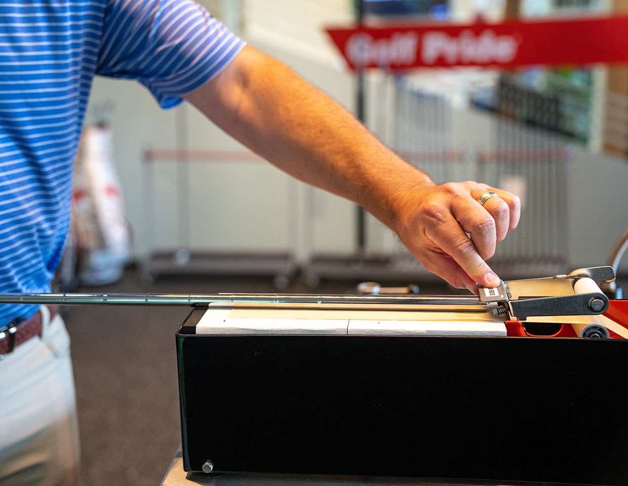 Golf Pride employee installing a new grip