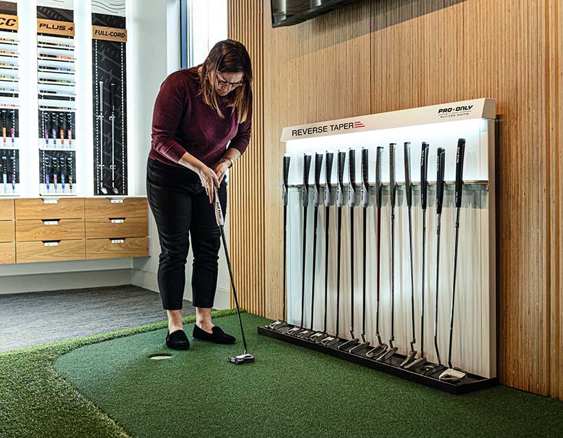 woman testing putter grip